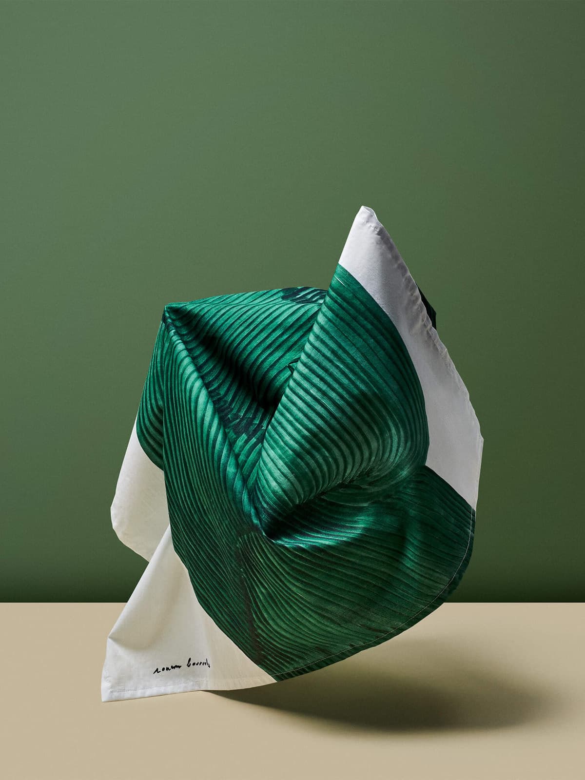 Green folded textile still life